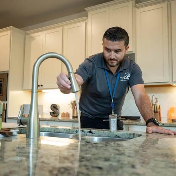 Home inspector checking a kitchen faucet