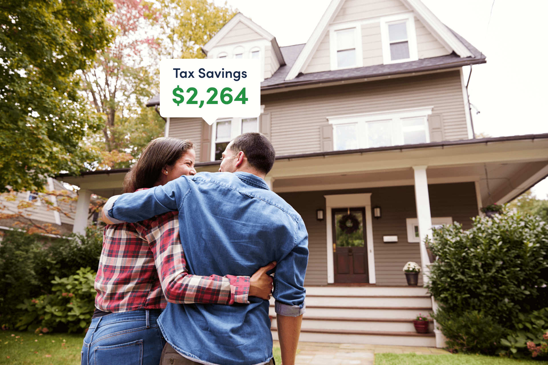 Couple standing in front of house